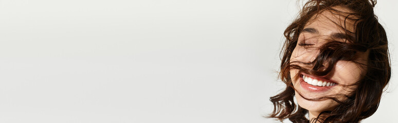 Young woman with stunning makeup enjoying a playful moment in the studio