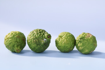 Kafir limes are small, round, green citrus fruits known for their bumpy texture and aromatic leaves. They are often used in cooking and traditional remedies, adding unique flavor to dishes
