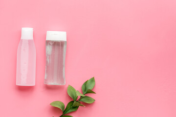 mycelial water, lotion for skin care and plant on pink background flat lay space for text