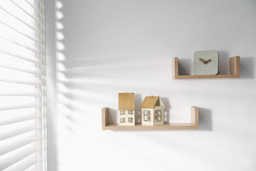 Wooden shelves with decor on white wall