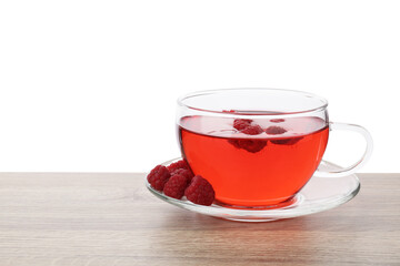 Tasty raspberry tea and berries on wooden table against white background