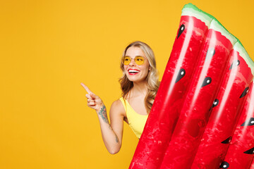 Young sexy woman wear bikini swimsuit sunglasses rest near hotel pool hold inflatable watermelon...