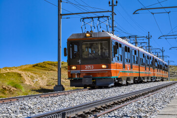 Historical photograph of an electric railcar departing from Gornergrat and descending to Zermatt...