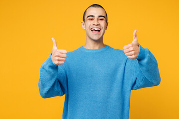 Young smiling happy cheerful fun middle eastern man wearing blue sweatshirt casual clothes showing...