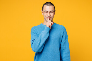 Young secret middle eastern man wearing blue sweatshirt casual clothes say hush be quiet with...