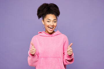 Young smiling happy cheerful satisfied woman of African American ethnicity wear pink hoodie casual...