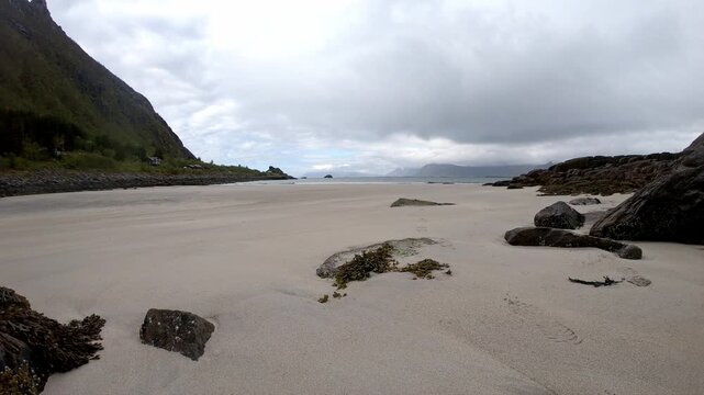 Timelapse from Rorvikstranda in Lofoten showing sand, traffic, ocean and fast-moving clouds