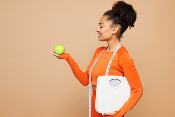 Young strong fitness trainer instructor sporty woman she wear orange clothes spend time in home gym...
