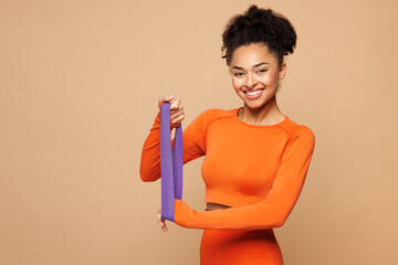 Young strong fitness trainer instructor sporty woman sportsman wear orange clothes spend time in...