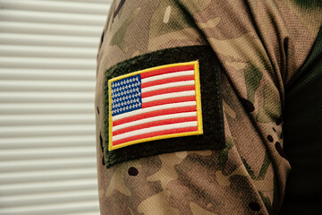 Fragment of military clothing with US flag patch. Army equipment in close-up.
