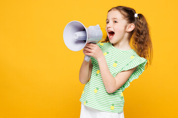 Little kid child girl 8-9 years old wears green t-shirt hold in hand megaphone scream announces...