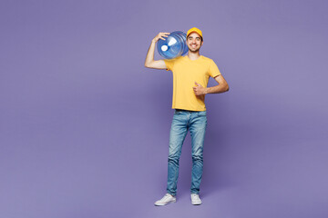 Full body young delivery guy employee man he wear yellow cap t-shirt uniform workwear work dealer...