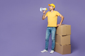 Full body young delivery guy employee man wear yellow cap t-shirt uniform workwear work as dealer...
