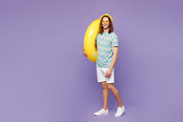 Full body side profile view young man wear blue beach t-shirt yellow hat sunglasses rest near hotel...