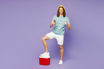 Full body young man wear t-shirt yellow hat sunglasses rest near hotel pool hold beach cooler...