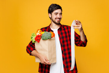 Young man wears casual clothes hold craft paper bag for takeaway mock up with food products read...