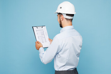 Side view young architect engineer designer employee man wear white clothes shirt hardhat hold...
