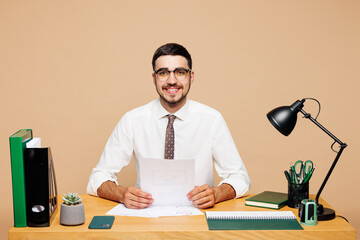 Young happy successful employee business man wear white shirt tie glasses sit work at office desk...