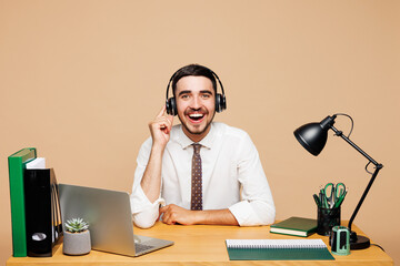 Young cheerful successful employee business man wear white shirt tie sit work at office desk with...