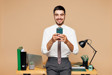 Young happy employee business man wear white shirt tie work at office stand near desk with pc...