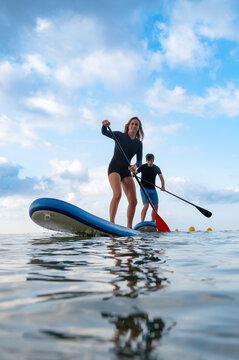 Couple engaged in paddleboard contest on the water