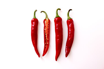 Place whole and halved chili peppers together on a white background.