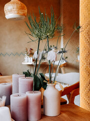 Elegant table arrangement with candles and fresh flowers in cozy interior space