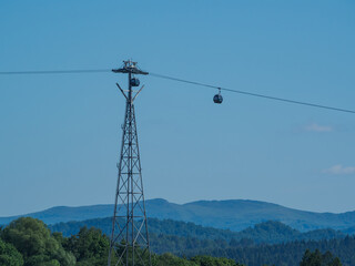 Cable Car Over Solina Lake Dam at Dusk with Full Moon in the Background, Bieszczady Mountains,...