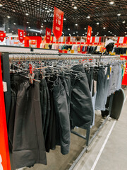 Clothes display features various styles of shorts in a retail setting during daylight hours