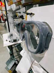 Diving masks displayed for sale in a sporting goods store aisle during the daytime