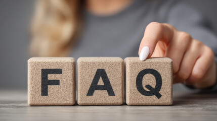 Close-Up of Hand Toggling FAQ Blocks on Wooden Surface