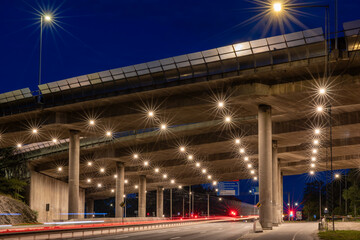 Stockholm, Sweden Traffic streaks at night under the E4 highway bridge in Liljeholmen.