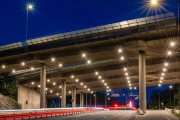Stockholm, Sweden Traffic streaks at night under the E4 highway bridge in Liljeholmen.