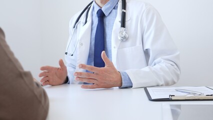 Close-up of a doctor reviewing digital test results with patient, discussing health findings on laptop screen during clinical consultation. Medicine and health care concept