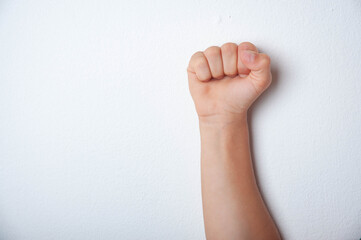 Child boy with fist up on a white background.