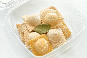 A Delightful Assortment of Freshly Made Ravioli Stuffed with Flavorful Filling, Perfectly Arranged and Garnished with Aromatic Bay Leaf
