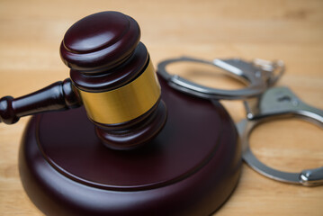 Hammer judge gavel and handcuffs in courtroom on wooden table background. Law legal, arrest, legal...