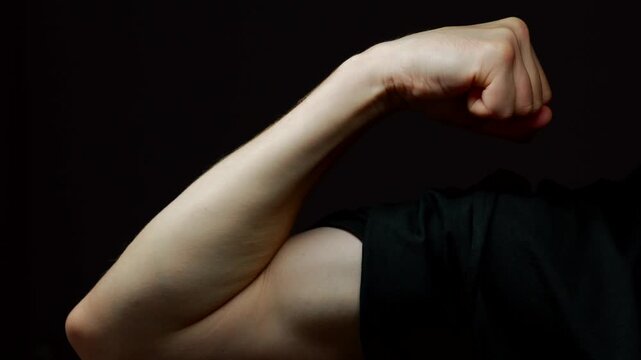 Torso of a naked man with a strong bicep.
Skinny and naked torso of a guy with a pumped up arm and a strong bicep.
Man shows biceps on his arm close-up