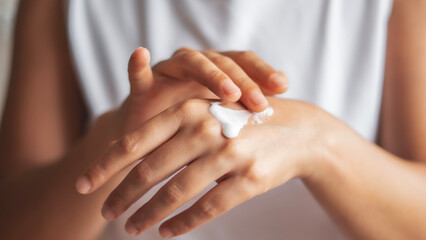 skincare. close up view of woman hand moisturising them with cream. skincare