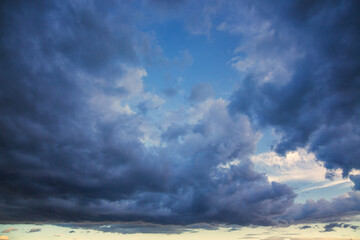 Dark rain clouds cover the sky, dark storm clouds high in the sky, sharp weather change, cloudy...