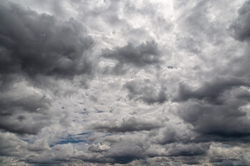 Dense gray clouds covered the sky, gray heavy clouds, large cloudiness and bad weather, blurred...