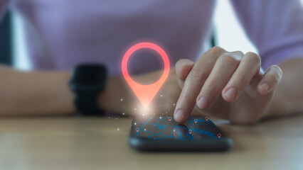Hand tapping on smartphone with GPS map and location pin hologram, symbolizing navigation,...