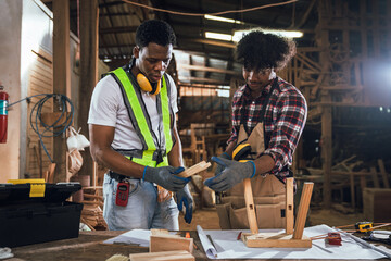 Factory Workers Discussing Work in Timber Sawmill, Two African American Men Collaborating in...