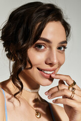 Stunning young woman showcasing elegant makeup in a stylish studio setting