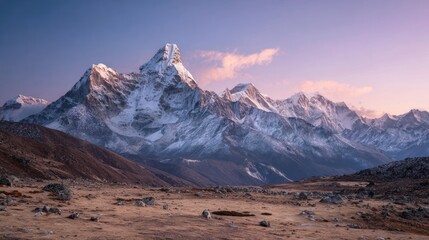 A majestic, snow-capped mountain range under a soft pink and blue sky