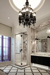 Luxurious bathroom with glass shower, black chandelier, and opulent marble walls and floor.