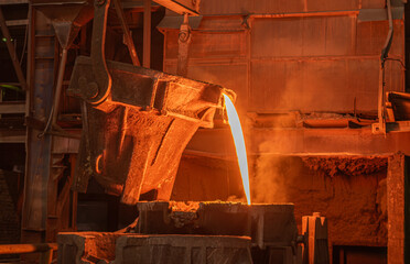 Molten metal pours out of a ladle