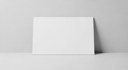 Blank White Canvas Poster Standing Against Light Gray Wall