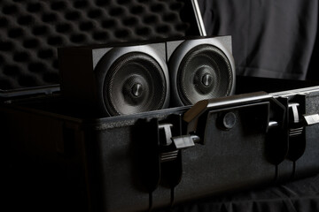 A pair of hi‑fi speakers secured in a military‑grade protective case with acoustic foam,...