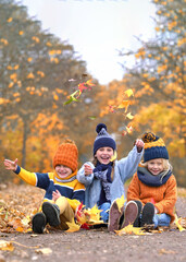 Autumn Delight: Kids Tossing Colorful Leaves in Joy